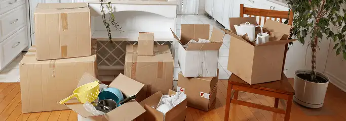 Packed moving boxes and household items in a kitchen before move-out or move-in cleaning, Rochester, NY.